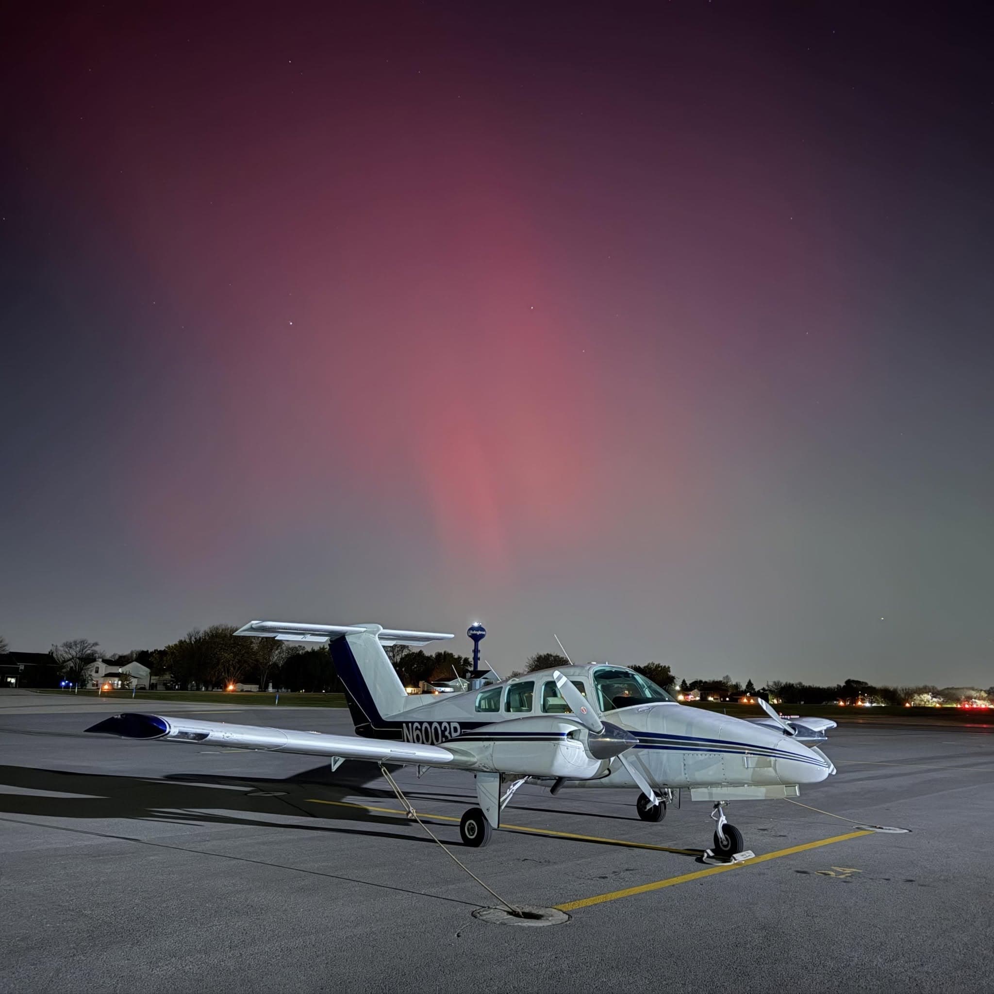 Beechcraft Duchess N6003P on the ramp under the northern lights